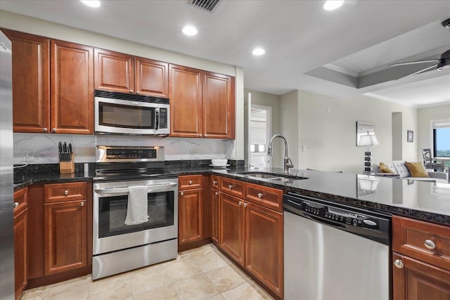 121 N Monroe St, Tallahassee, FL 32301 - kitchen featuring appliances with stainless steel finishes, backsplash, dark stone countertops, recessed lighting, and ornamental molding