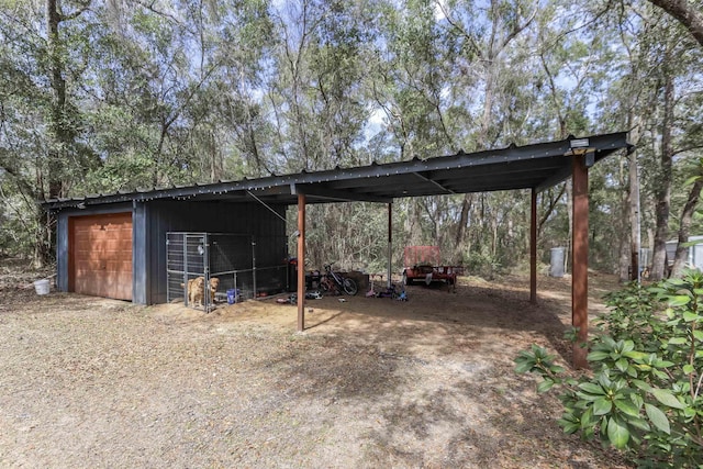 10446 Rose Rd, Tallahassee, FL 32311 - view of outdoor structure featuring a garage, an outbuilding, driveway, and a carport