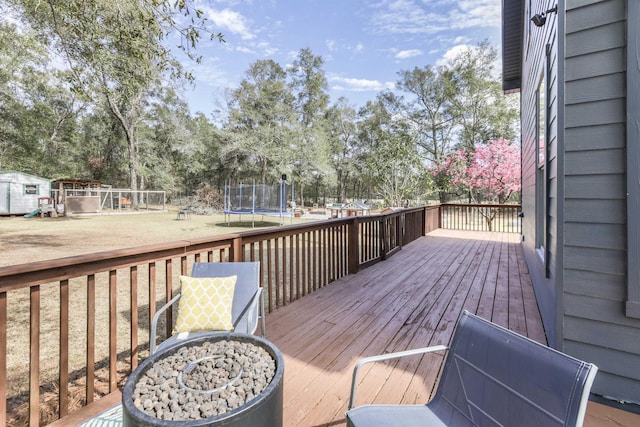 10446 Rose Rd, Tallahassee, FL 32311 - wooden terrace with a playground, a lawn, and a trampoline