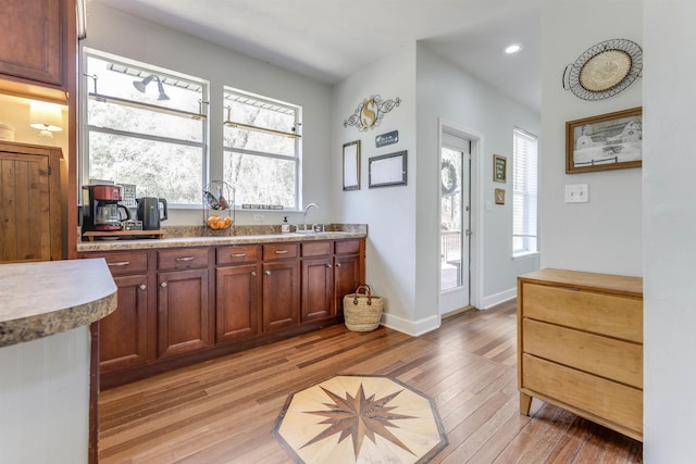10446 Rose Rd, Tallahassee, FL 32311 - kitchen featuring light wood-style flooring, a sink, baseboards, and recessed lighting