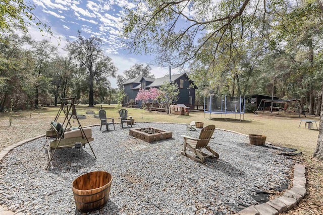 10446 Rose Rd, Tallahassee, FL 32311 - view of yard with an outdoor fire pit, a playground, and a trampoline