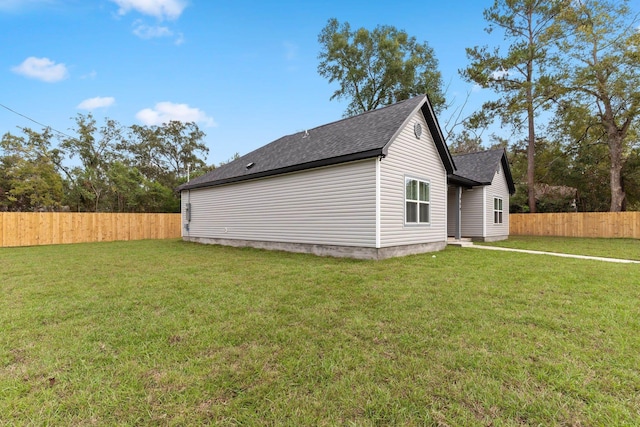 view of side of property with a yard