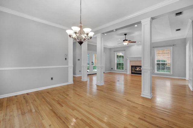 4012 Dutchess Ct, Tallahassee, FL 32309 - unfurnished living room featuring a ceiling fan, light wood-style flooring, a fireplace with flush hearth, ornate columns, and a chandelier