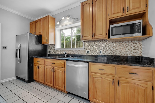 4012 Dutchess Ct, Tallahassee, FL 32309 - kitchen featuring appliances with stainless steel finishes, crown molding, decorative backsplash, light tile patterned flooring, and dark stone countertops