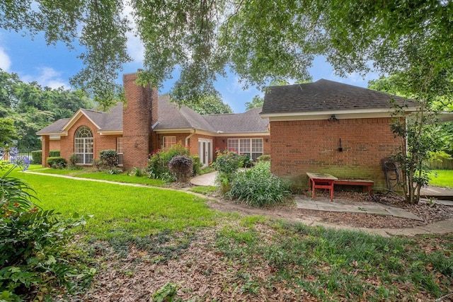 4012 Dutchess Ct, Tallahassee, FL 32309 - rear view of property with a yard, a chimney, and brick siding