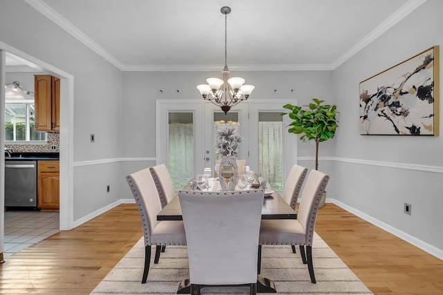 4012 Dutchess Ct, Tallahassee, FL 32309 - dining area with a chandelier, light wood finished floors, and crown molding