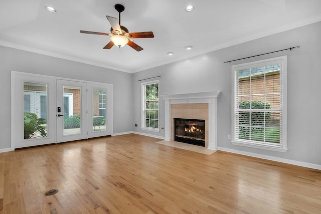 4012 Dutchess Ct, Tallahassee, FL 32309 - unfurnished living room featuring plenty of natural light, ceiling fan, a fireplace, ornamental molding, and light wood finished floors