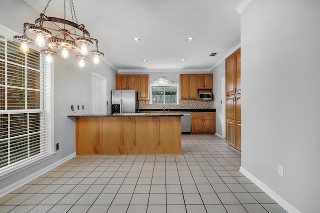 4012 Dutchess Ct, Tallahassee, FL 32309 - kitchen featuring stainless steel appliances, a peninsula, backsplash, crown molding, and a chandelier