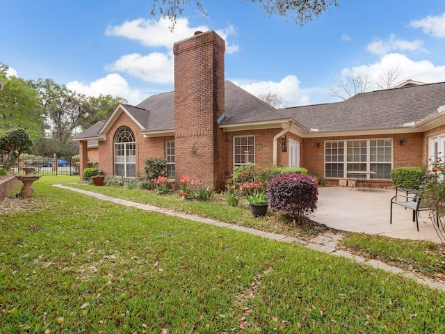 4012 Dutchess Ct, Tallahassee, FL 32309 - rear view of property featuring brick siding, a patio area, a chimney, and roof with shingles
