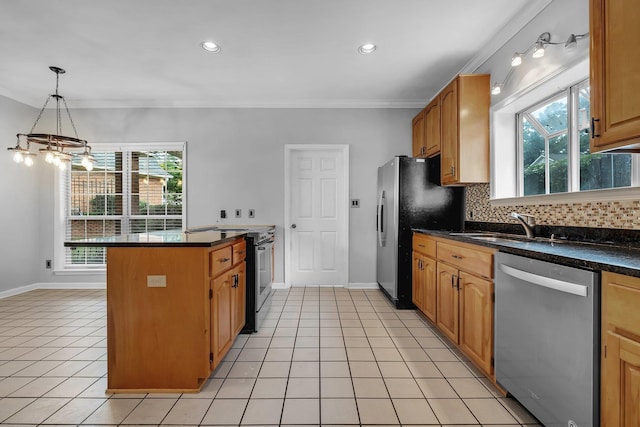 4012 Dutchess Ct, Tallahassee, FL 32309 - kitchen featuring stainless steel appliances, healthy amount of natural light, a peninsula, dark countertops, and ornamental molding