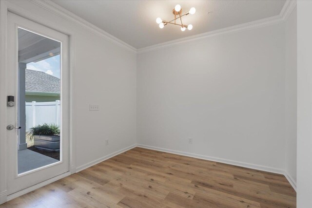 4312 Four Oaks Blvd, Tallahassee, FL 32311 - empty room featuring a chandelier, ornamental molding, and light wood-style floors