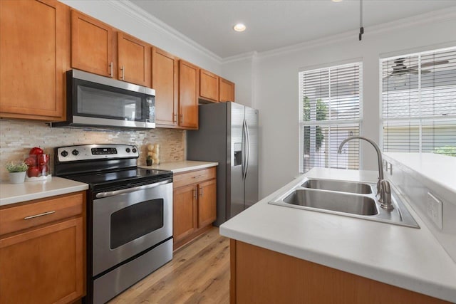 4312 Four Oaks Blvd, Tallahassee, FL 32311 - kitchen featuring stainless steel appliances, crown molding, light wood-style flooring, decorative backsplash, and brown cabinets