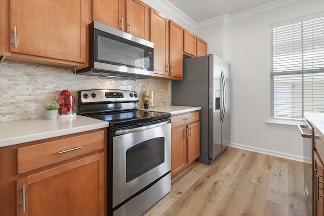 4312 Four Oaks Blvd, Tallahassee, FL 32311 - kitchen featuring appliances with stainless steel finishes, ornamental molding, light wood finished floors, tasteful backsplash, and light countertops
