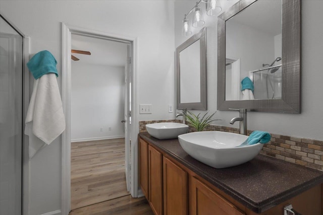 4312 Four Oaks Blvd, Tallahassee, FL 32311 - full bath featuring double vanity, wood finished floors, a shower, and backsplash