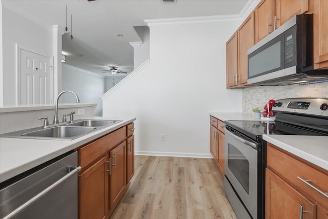 4312 Four Oaks Blvd, Tallahassee, FL 32311 - kitchen with stainless steel appliances, ornamental molding, light wood-type flooring, tasteful backsplash, and light countertops