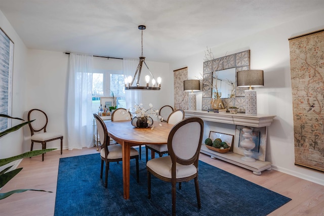 dining room featuring light hardwood / wood-style flooring and a chandelier