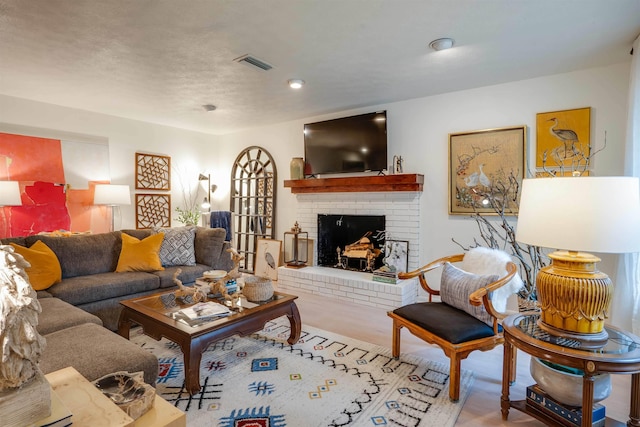 living room with a fireplace and light hardwood / wood-style floors