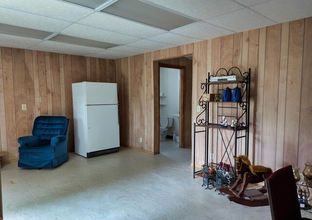 491 NE Dusty Miller Ave, Madison, FL 32340 - sitting room with tile patterned floors, wood walls, and a drop ceiling