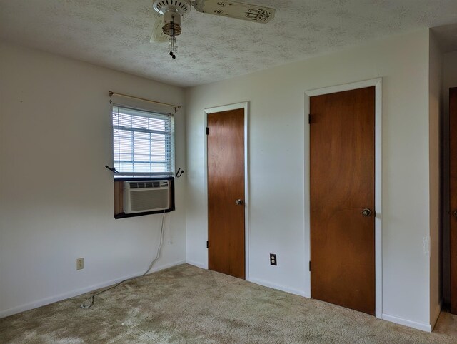 491 NE Dusty Miller Ave, Madison, FL 32340 - unfurnished bedroom featuring carpet, baseboards, a textured ceiling, and cooling unit