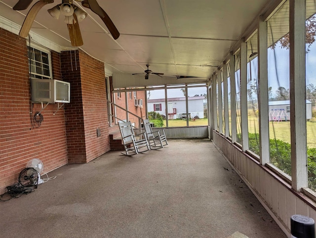 unfurnished sunroom featuring ceiling fan