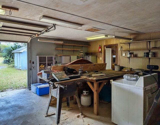 garage with washer / dryer and wooden walls