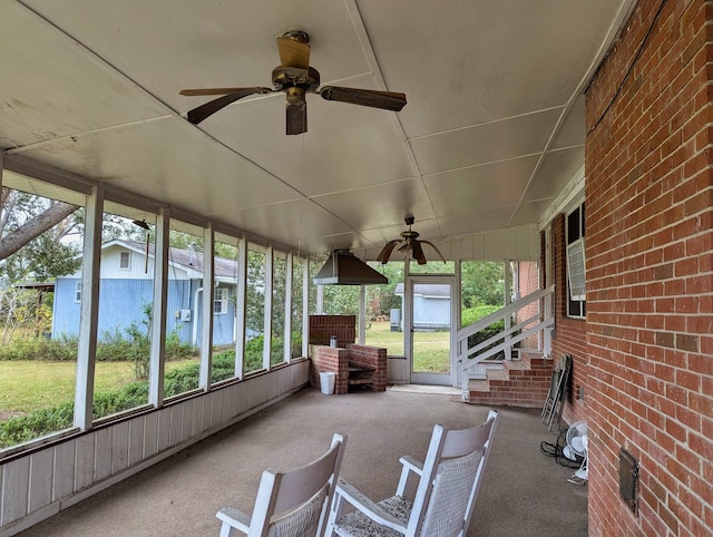 unfurnished sunroom featuring ceiling fan