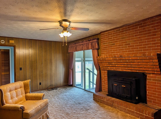 unfurnished living room with wood walls, a textured ceiling, carpet flooring, and ceiling fan