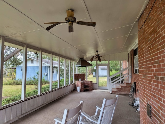 unfurnished sunroom with ceiling fan