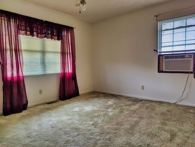 empty room with light colored carpet, cooling unit, and ceiling fan