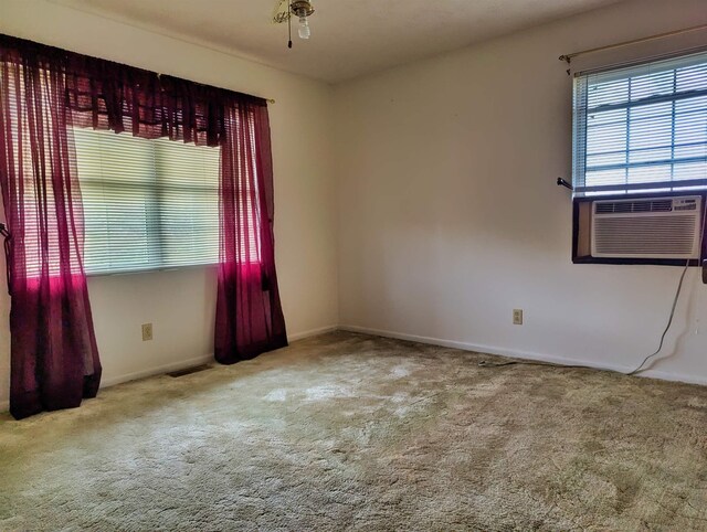 491 NE Dusty Miller Ave, Madison, FL 32340 - empty room featuring carpet floors, baseboards, and cooling unit