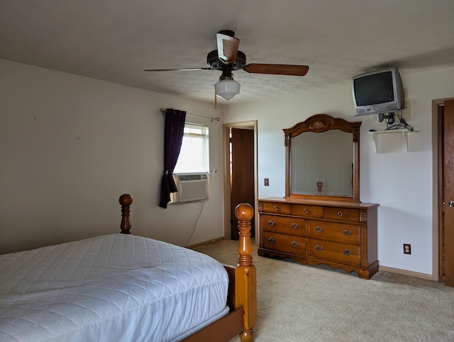 carpeted bedroom featuring ceiling fan, a textured ceiling, and cooling unit