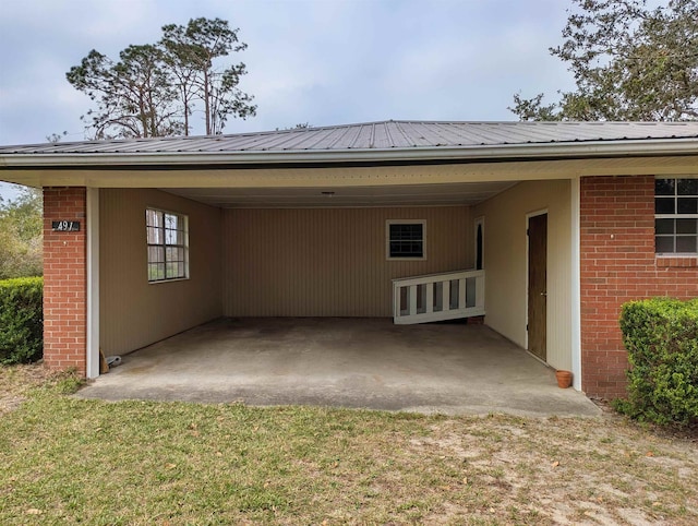 rear view of property with a carport and a lawn