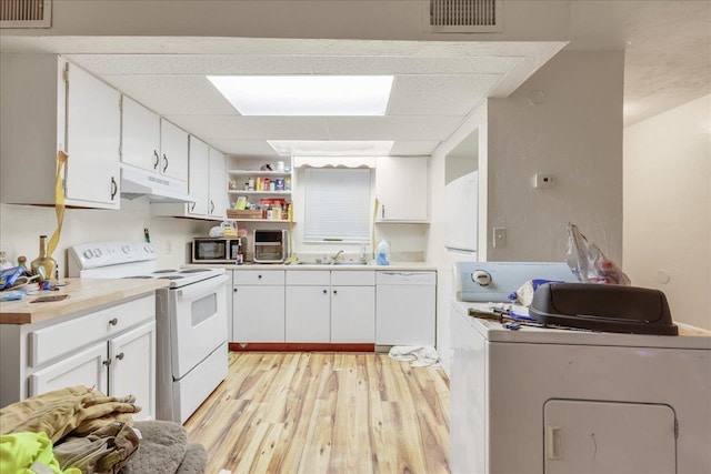 1286 Rumba Ln -, Unit Tallahassee, FL 32304 - kitchen with white appliances, washer / dryer, under cabinet range hood, light wood-style flooring, and white cabinets