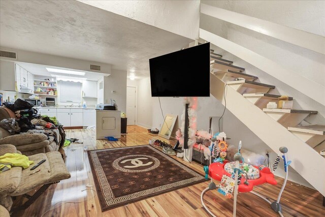 1286 Rumba Ln -, Unit Tallahassee, FL 32304 - living area featuring washer / dryer, light wood finished floors, and stairway