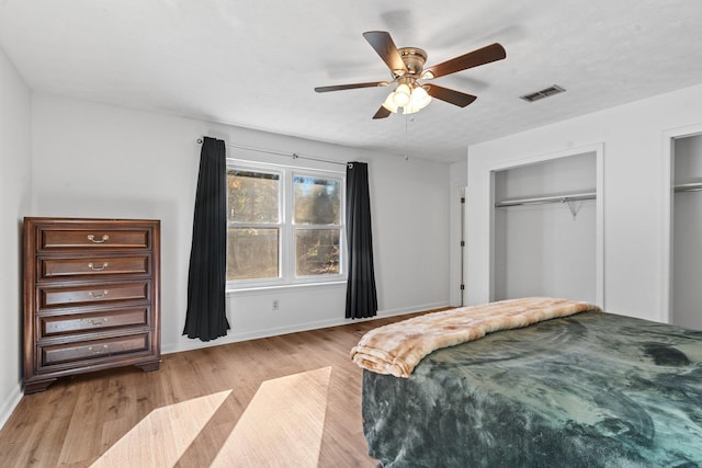 1909 Ermine Ct, Tallahassee, FL 32308 - bedroom with light wood finished floors, two closets, and a ceiling fan