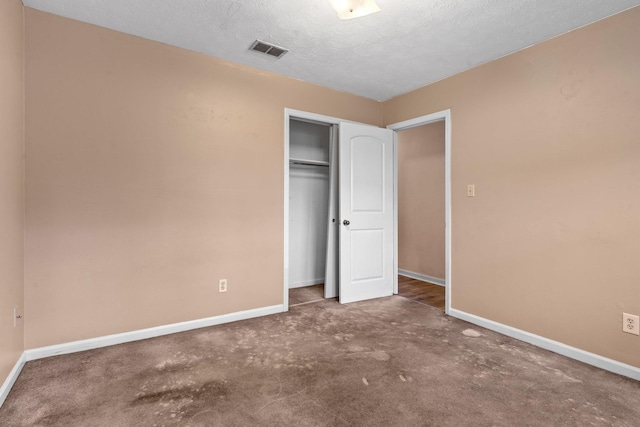 1909 Ermine Ct, Tallahassee, FL 32308 - unfurnished bedroom with a closet, carpet floors, and a textured ceiling