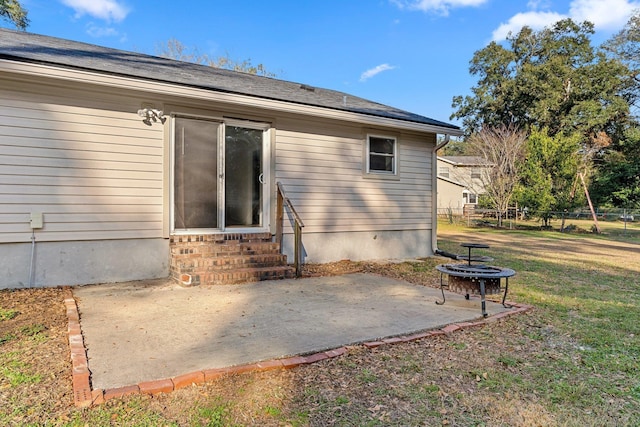 1909 Ermine Ct, Tallahassee, FL 32308 - rear view of house with entry steps, a patio, and an outdoor fire pit