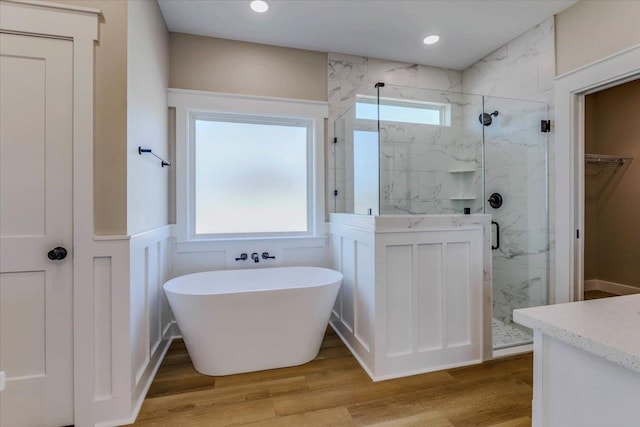 bathroom featuring vanity, hardwood / wood-style floors, and separate shower and tub