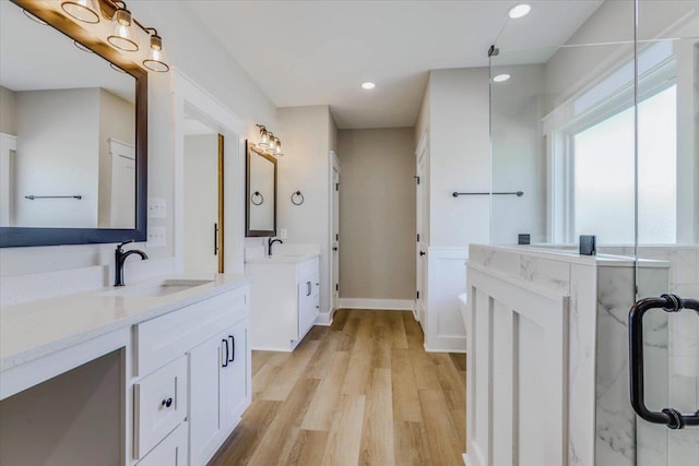 bathroom with vanity, hardwood / wood-style floors, and an enclosed shower