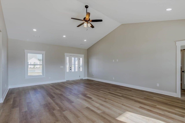 unfurnished living room with french doors, ceiling fan, high vaulted ceiling, and light hardwood / wood-style floors