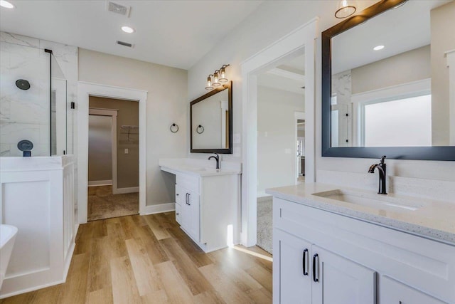 bathroom featuring vanity, hardwood / wood-style floors, and walk in shower