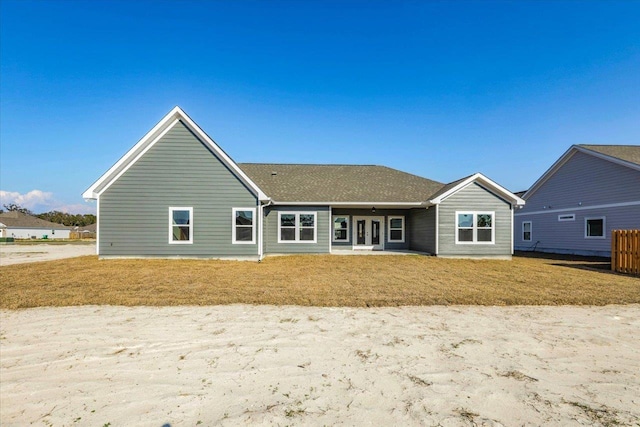 rear view of house with a yard