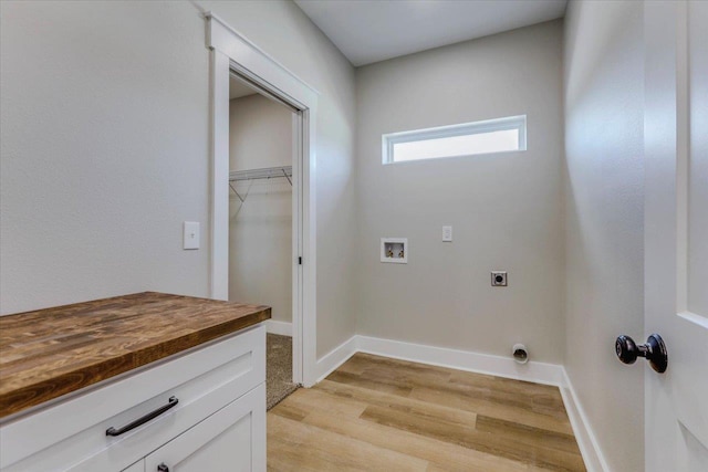 laundry room featuring hookup for a washing machine, electric dryer hookup, and light wood-type flooring