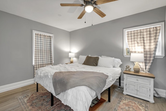 bedroom with ceiling fan and light wood-type flooring