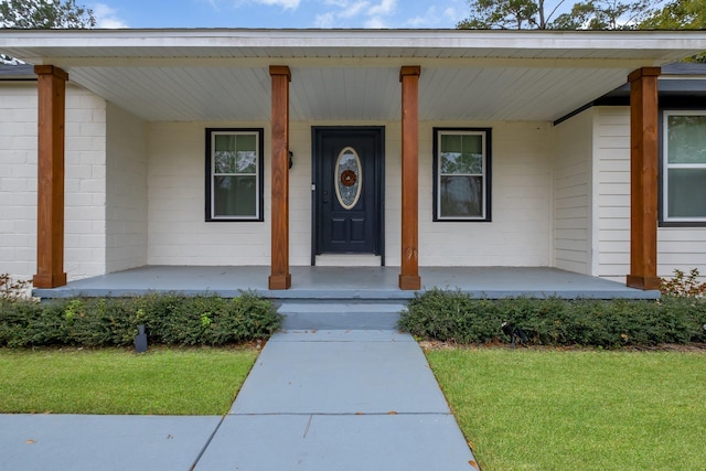 view of exterior entry with a porch