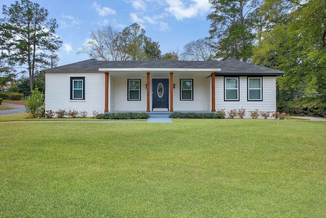 ranch-style house with a front yard and covered porch