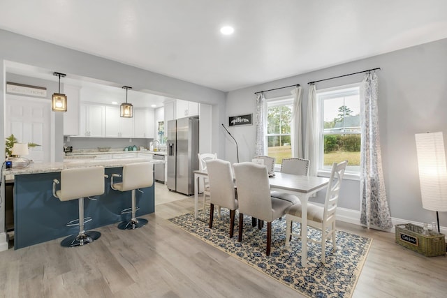 dining space with light hardwood / wood-style floors