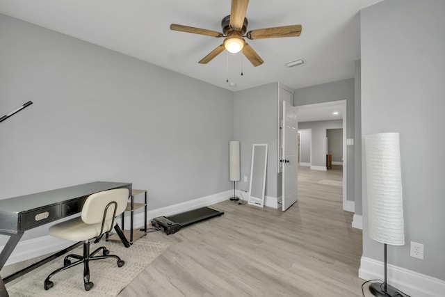 home office with ceiling fan and light hardwood / wood-style floors