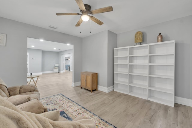living room featuring ceiling fan and light wood-type flooring