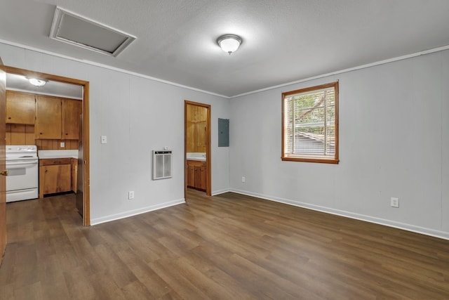 unfurnished room with dark hardwood / wood-style flooring, electric panel, crown molding, heating unit, and a textured ceiling